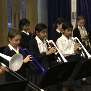 Juniors performing wind instruments in the concert.